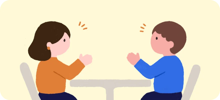 テーブルを挟んで向かい合い話し合う2人のイラスト